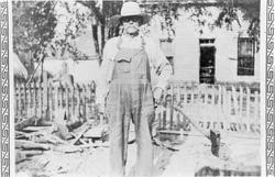 Charles Wesley Price (narrator's grandfather) standing in front of their home